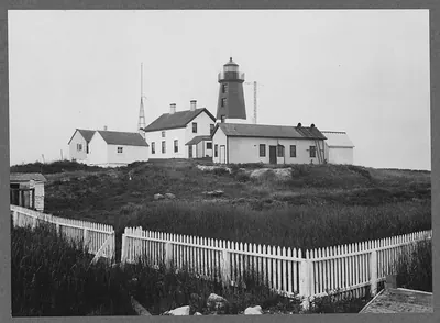 Lighthouse with keeper's house and white picket fence
