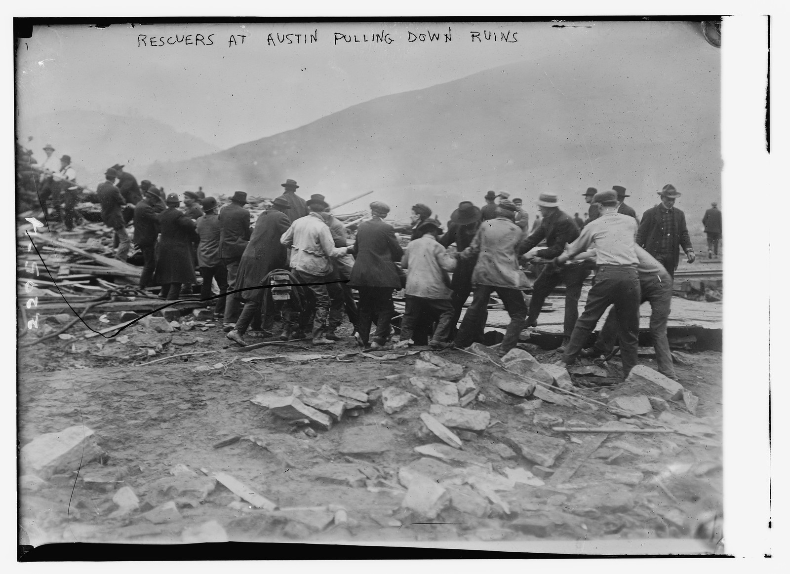 Rescuers at Austin pullin down ruins, n/a — historic photograph