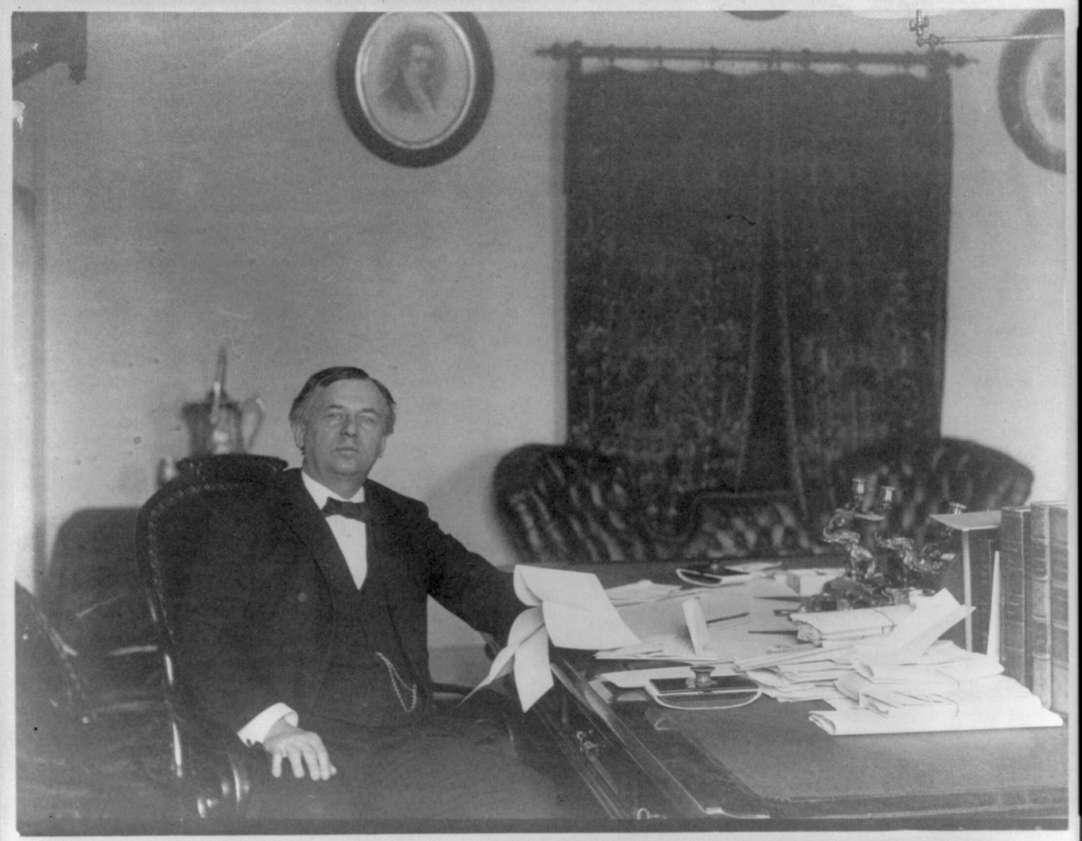 John Wanamaker, 1838-1922, three-quarter length portrait, seated, at desk, facing right, c1890. — historic photograph