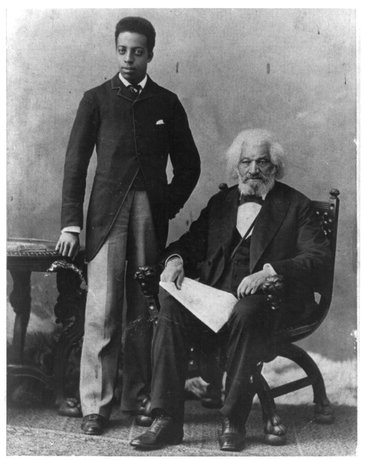 [Frederick Douglass, full length, seated beside grandson, facing front] — historic photograph