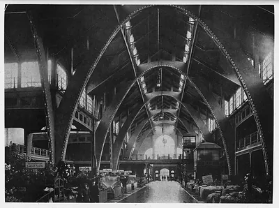 Interior of a market hall with steel arches and stalls