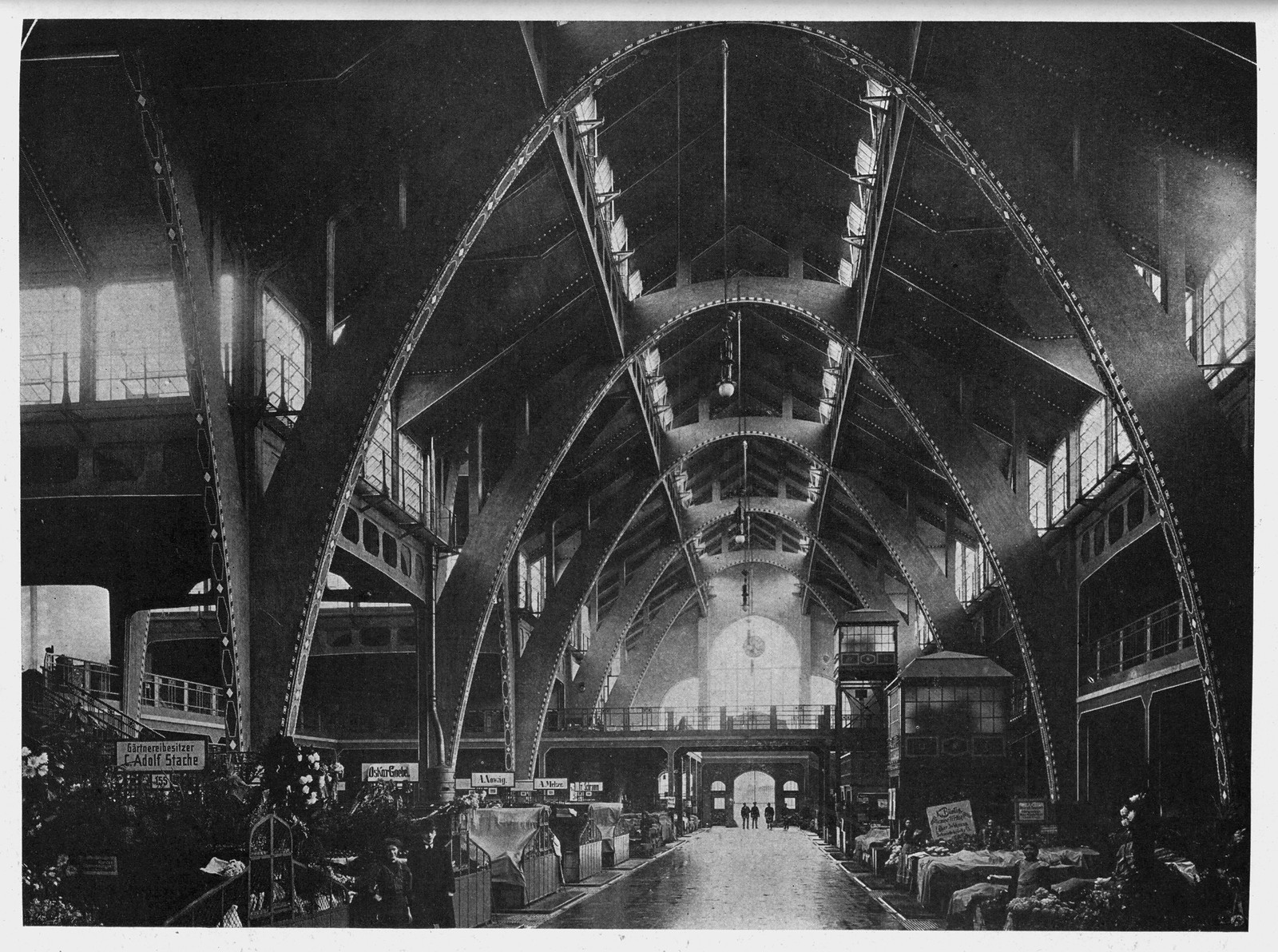 Interior of a market hall with steel arches and stalls — historic image