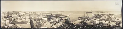 Panoramic view of a city and harbor with ships