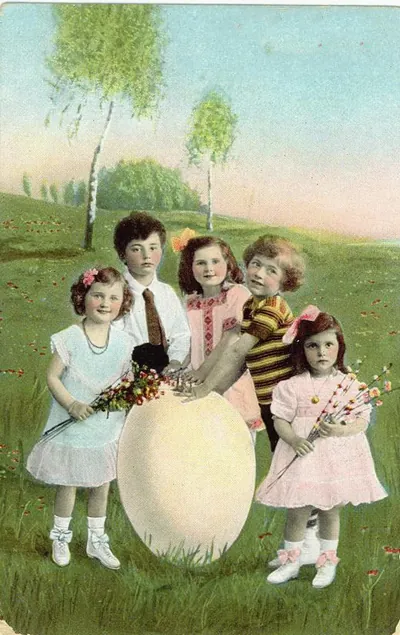 Children with a large Easter egg on a hand-tinted postcard