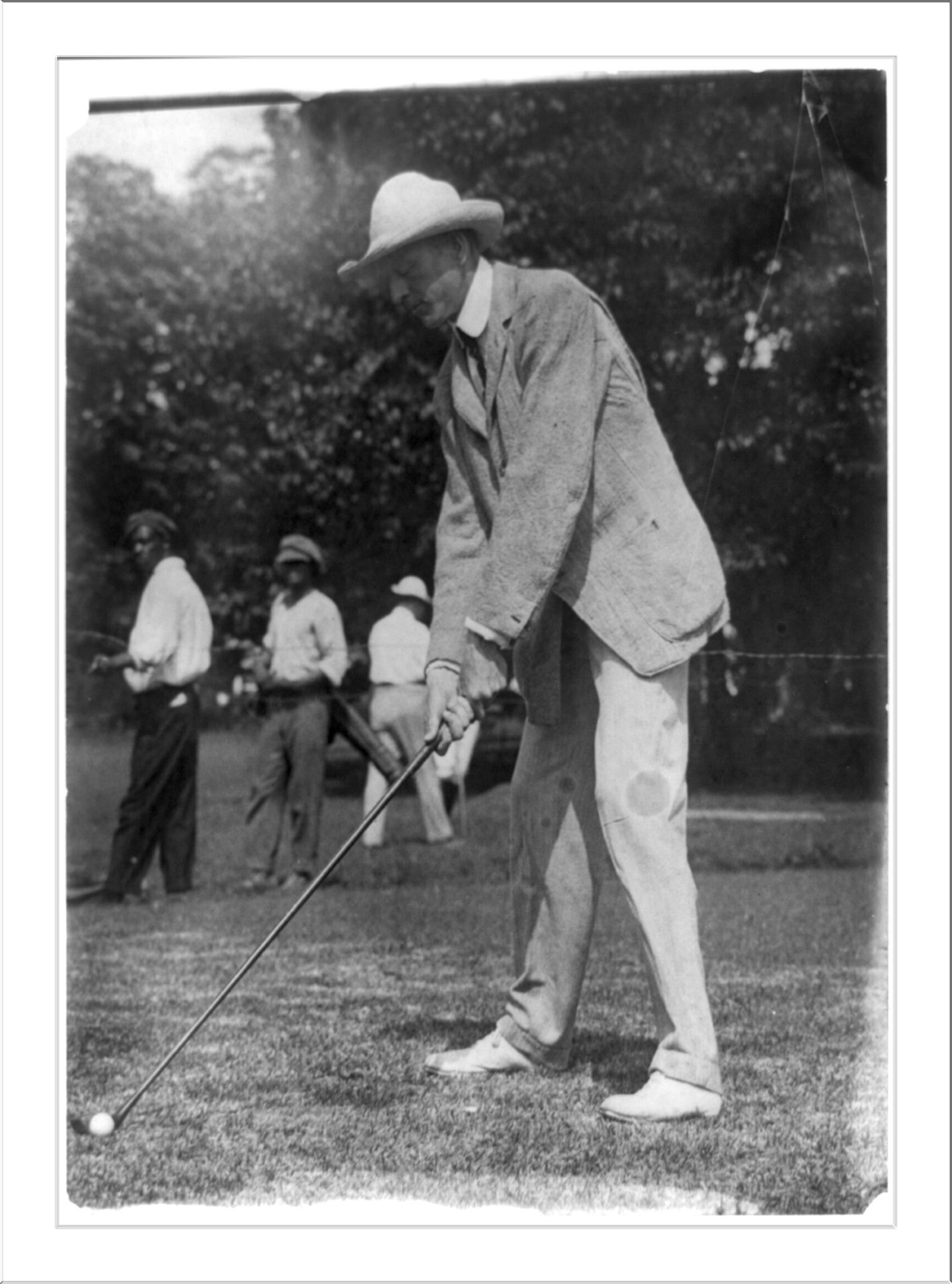 [Tuckerman swinging at golf ball, Washington, D.C., area], [between 1909 and 1932] — historic photograph