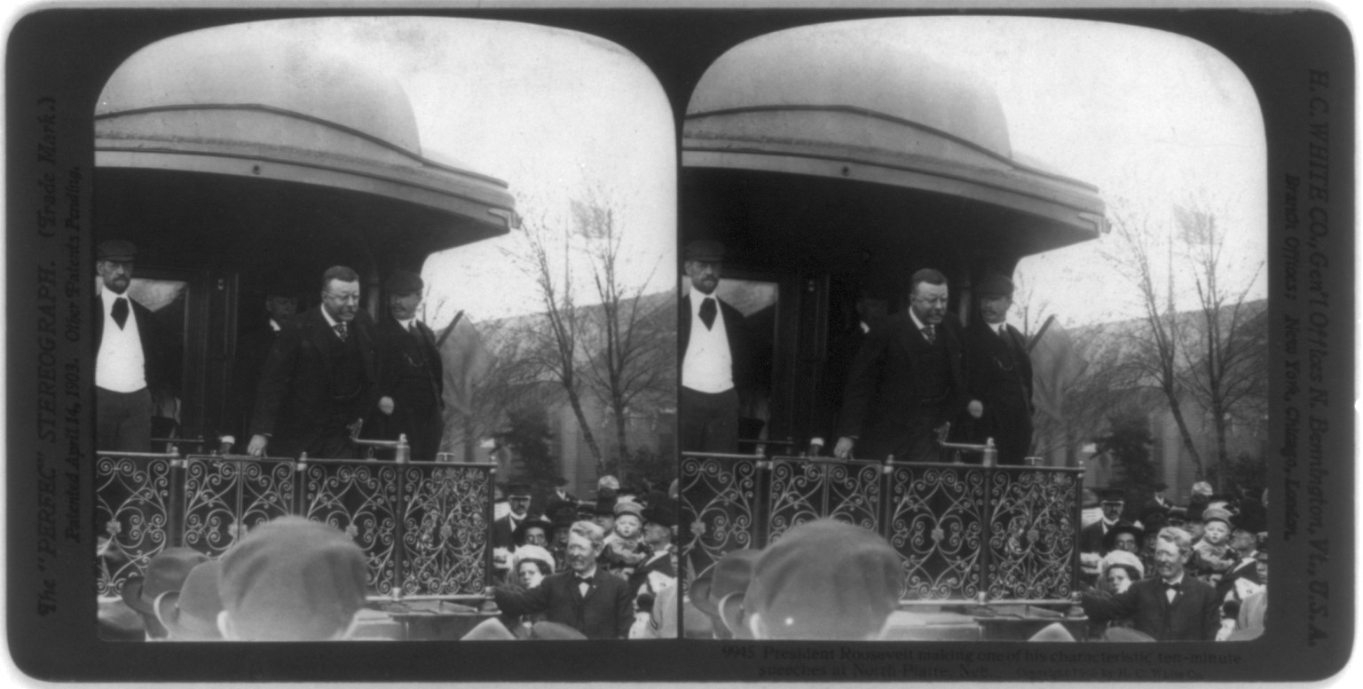 President [Theodore] Roosevelt making one of his characteristic ten-minute speeches [from back of train], North Platte, Neb., c1905. — historic photograph