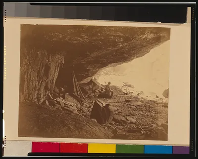 [Man seated beneath rock formation at the Upper Yosemite Fall, Yosemite National Park, Calif.]