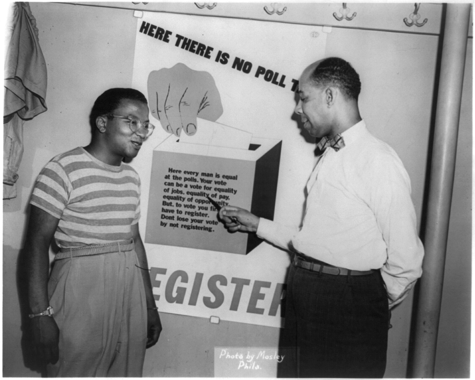 [Billy Strayhorn and Thomas L. Whaley standing next to sign promoting voter registration], [between 1940 and 1950] — historic photograph