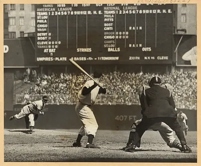 Batter at the plate, scoreboard reading N.Y. vs CLEVE