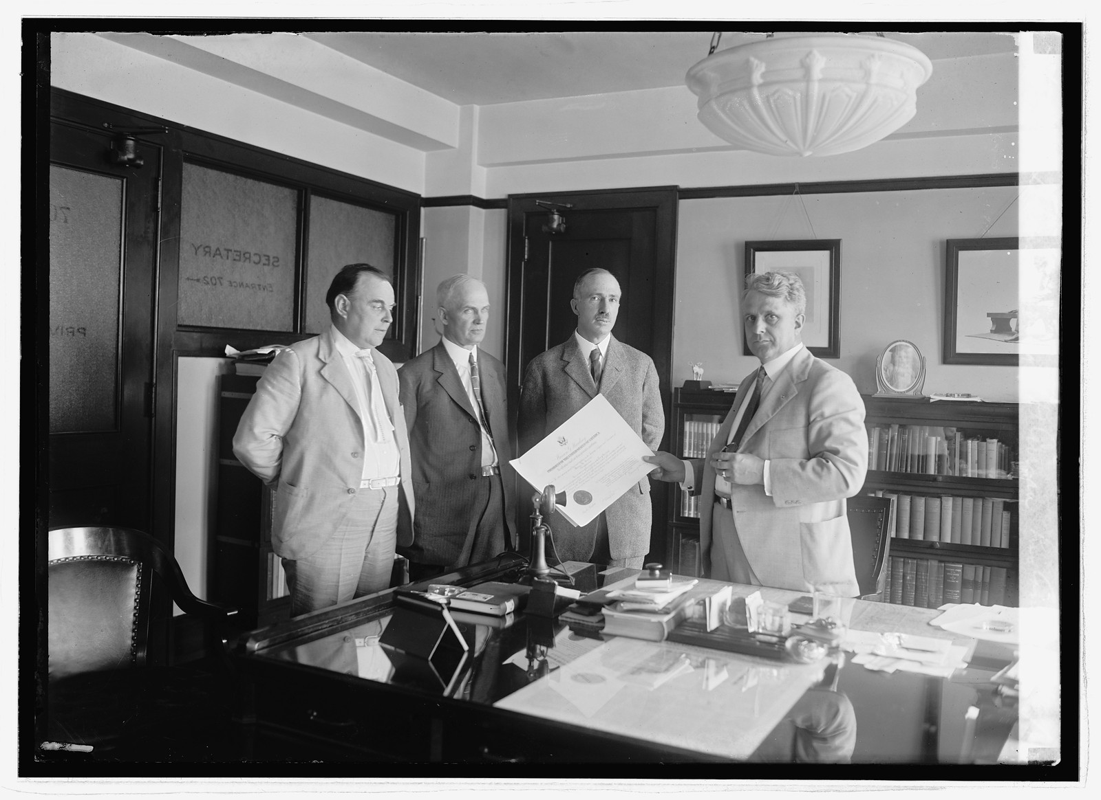 Davis handing H.A. Curran his commission, 6/16/23, [19]23 June 16. — historic photograph