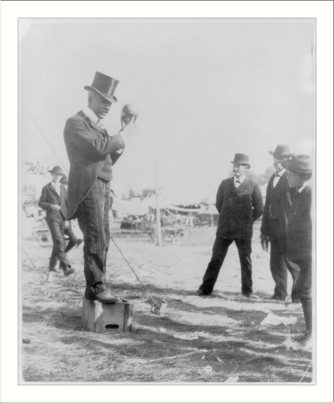 [Minnesota State Fair: African American on soap box using hand puppet], [1900?] — historic photograph