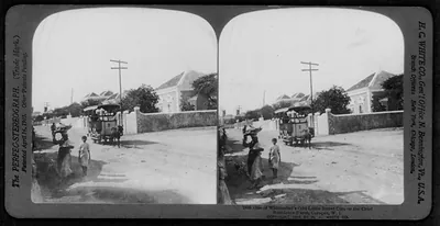 One of Willemstad's odd little street cars on the chief residence street, Curaçao, W.I.