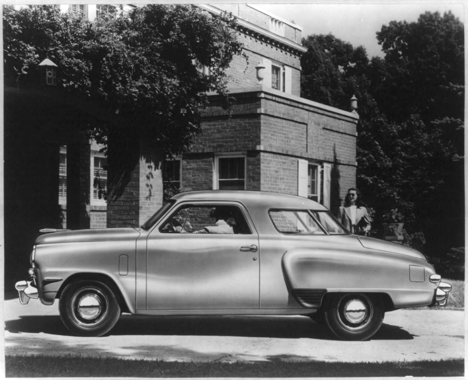 Side view of 1947 Studebaker automobile in driveway — historic photograph