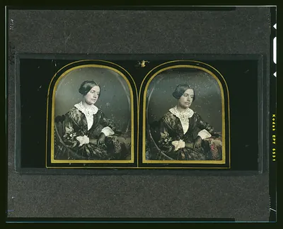 Hand-colored daguerreotype of a seated woman in a lace collar