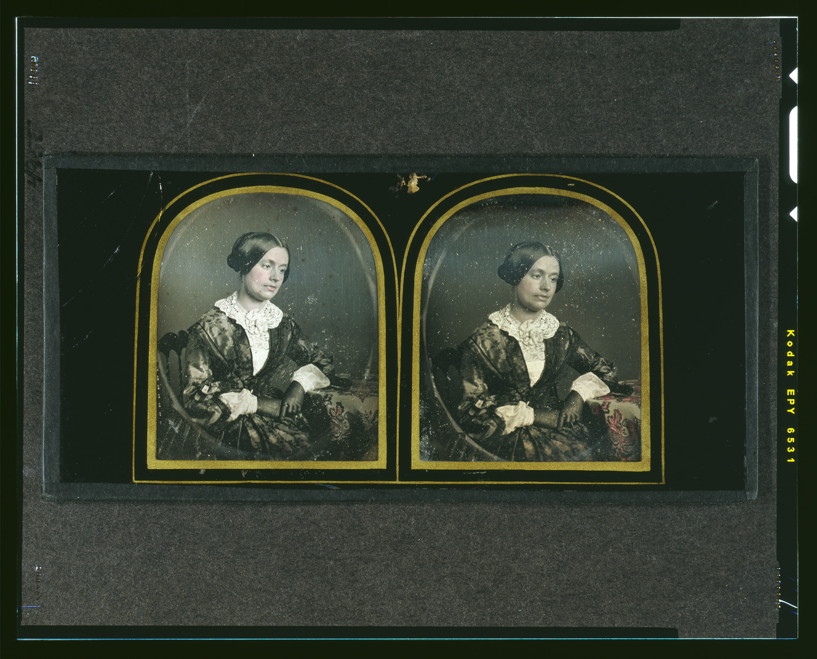 Hand-colored daguerreotype of a seated woman in a lace collar, 1850 — historic photograph