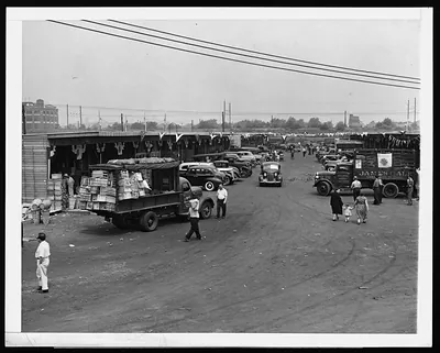 Trucks and crates at an outdoor produce market