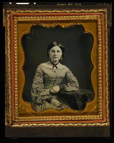 [Unidentified woman, half length portrait, seated with left arm resting on table with tablecloth]