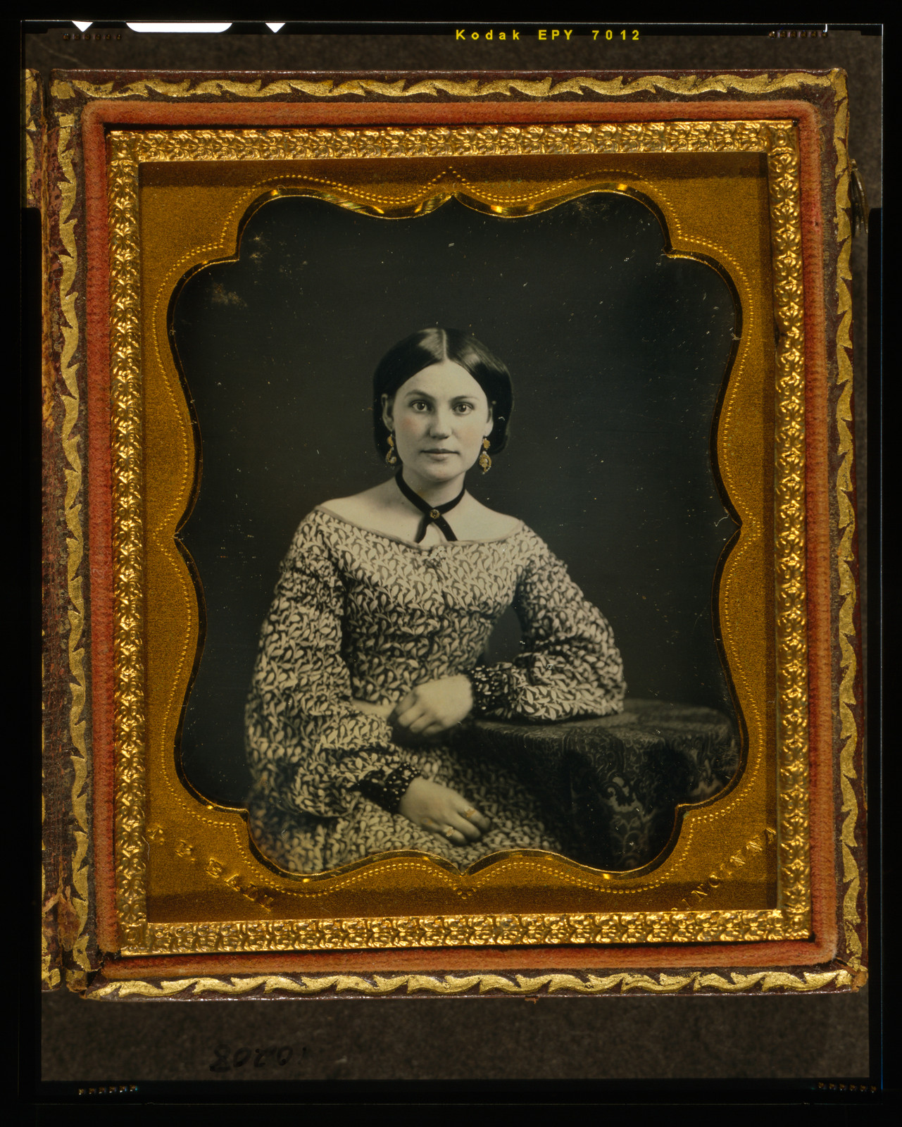 [Unidentified woman, half length portrait, seated with left arm resting on table with tablecloth], [between 1847 and 1860] — historic photograph