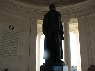 Bronze statue of Thomas Jefferson inside a memorial rotunda