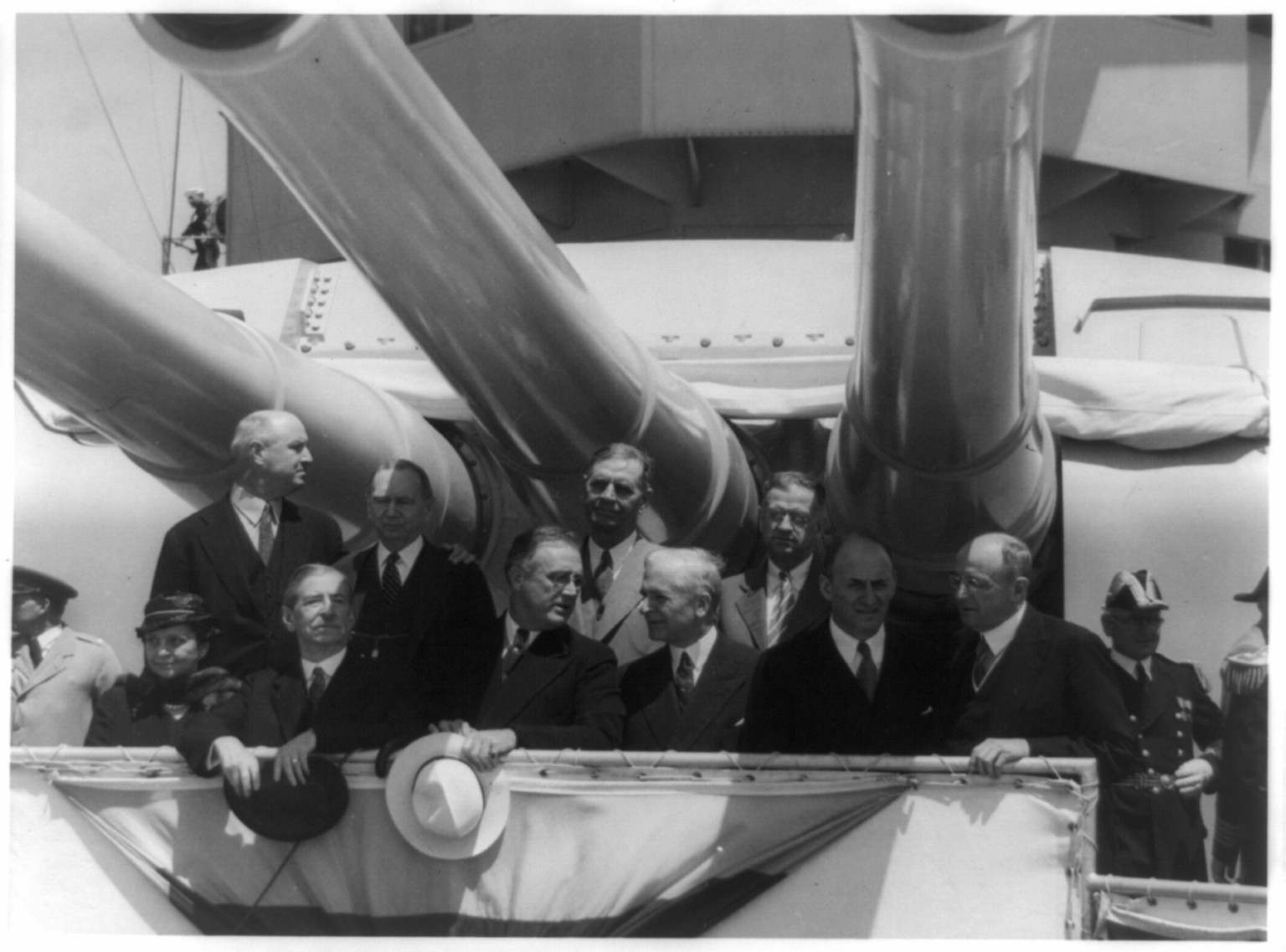 [Franklin D. Roosevelt and others posed under large guns on battleship], [between 1940 and 1945] — historic photograph
