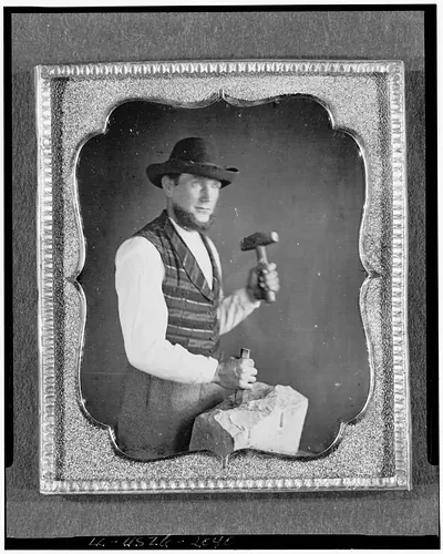 Daguerreotype portrait of a stonecutter with hammer and stone