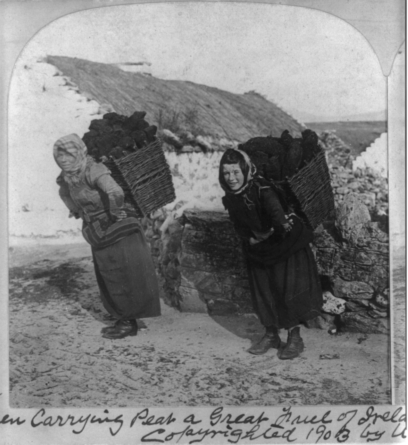 Women carrying peat, a great fuel of Ireland village Dooagh, Achill Island, Ireland, c1903. — historic photograph