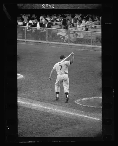 [Rear view of New York Yankee baseball player Mickey Mantle with bat swung over his shoulder] / Marvin E. Newman.