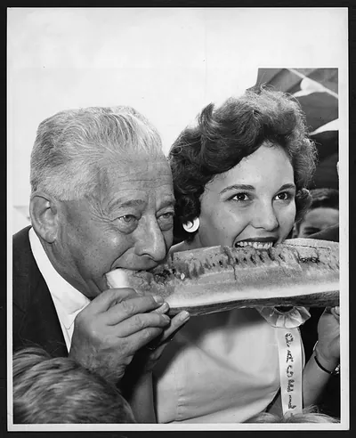 Smiling woman and older man eating a watermelon