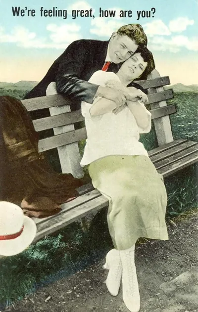 Hand-colored postcard of couple on bench, "We're feeling great, how are you?