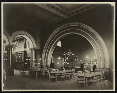 Reading room interior with arches, tables and chandeliers