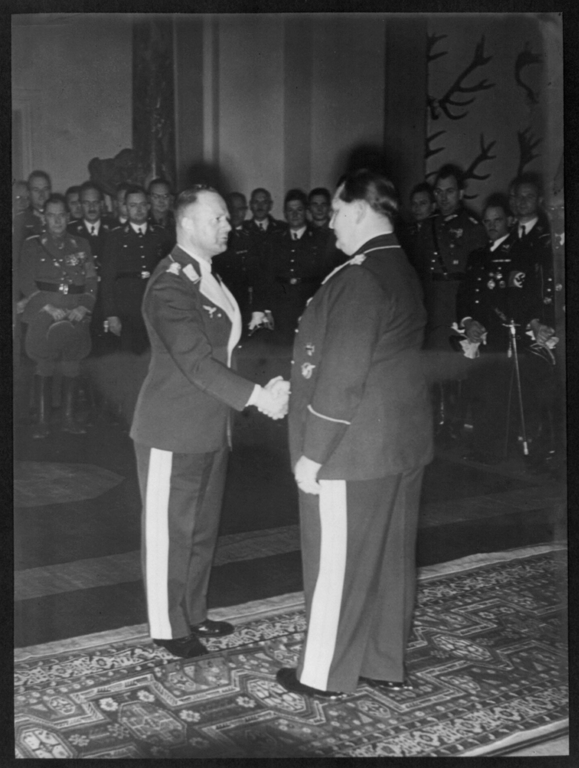 [Erhard Milch shaking Göring's hand during birthday celebration], [1938 January] — historic photograph
