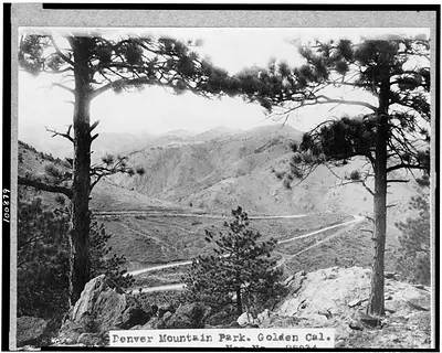 [Denver Mountain Park, Golden, Colorado. View through trees overlooking road and mountains]