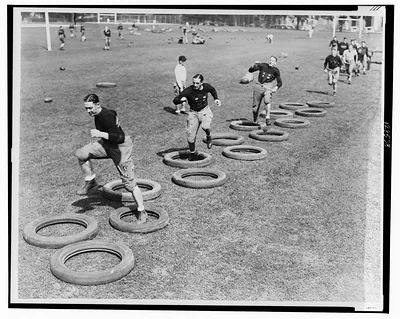 Wouldn't this tire you ?--Novel auto-tire dance limbers up this year's Army football team