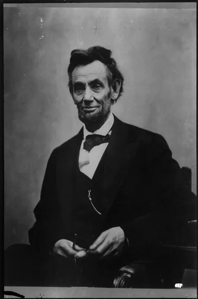 [Abraham Lincoln, half-length portrait, seated, with pencil and spectacles retouched]