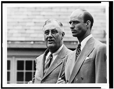 [Franklin D. Roosevelt, half-length portrait, standing, facing left, with his son, James Roosevelt]
