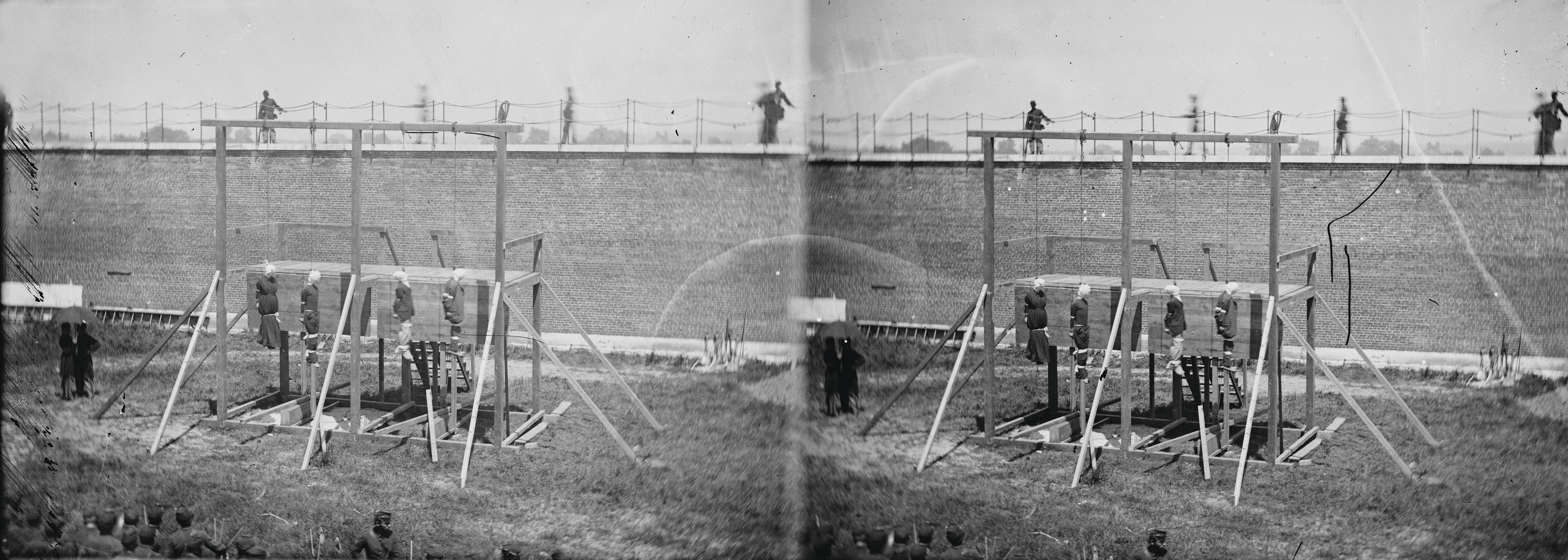 Stereo view of gallows before a brick prison wall — stereograph