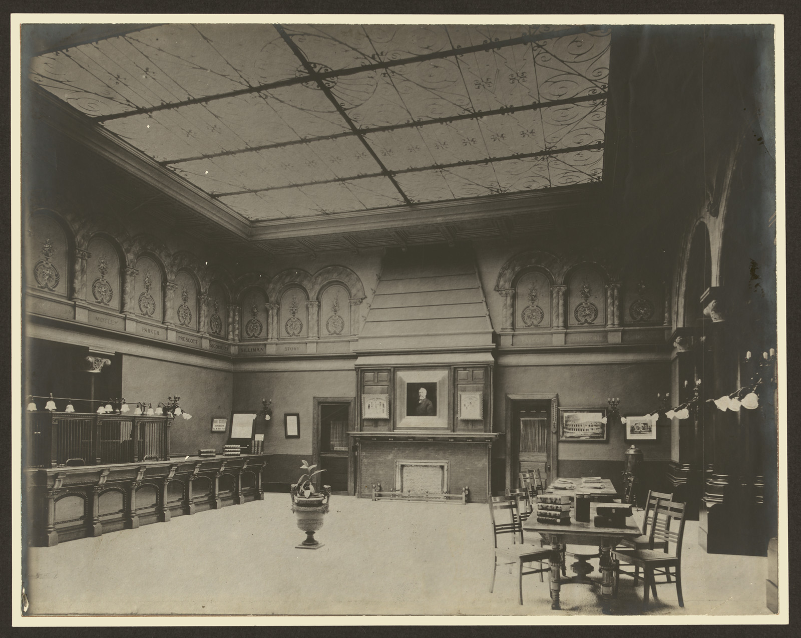 Interior of a library with ornate ceiling and fireplace — historic image