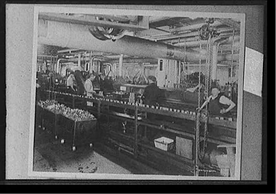 [Factory workers on assembly line for bearings]