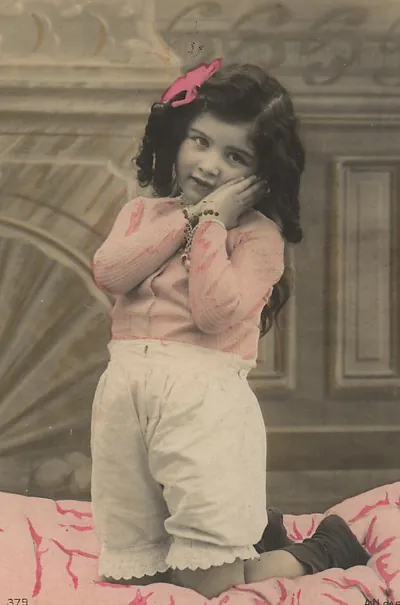 Hand-tinted photograph of a young girl posing