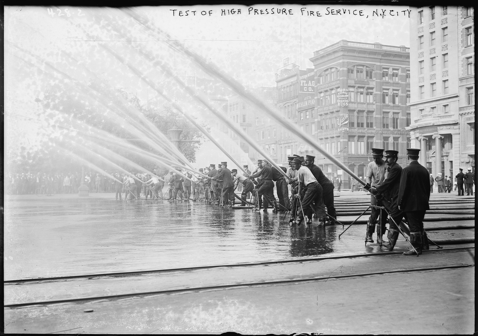 Fireman testing high-pressure hoses, New York, n/a — historic photograph