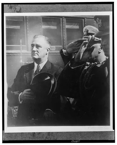 [Franklin D. Roosevelt, half-length portrait, standing, facing left, holding hat to his chest, and three men of the military saluting] / Wm. Edwin Booth.