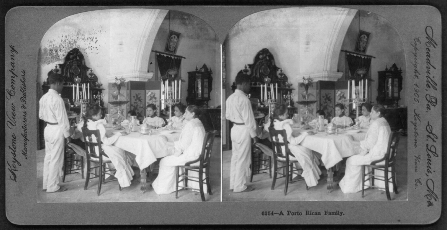 A Porto Rican family [around dining room table], c1905. — historic photograph