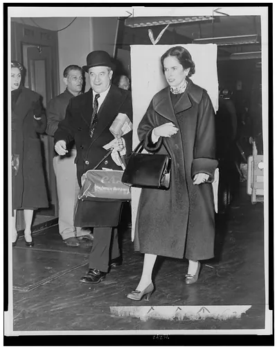 [Oona O'Neill Chaplin, accompanied by Arthur Kelly at New York International Airport]