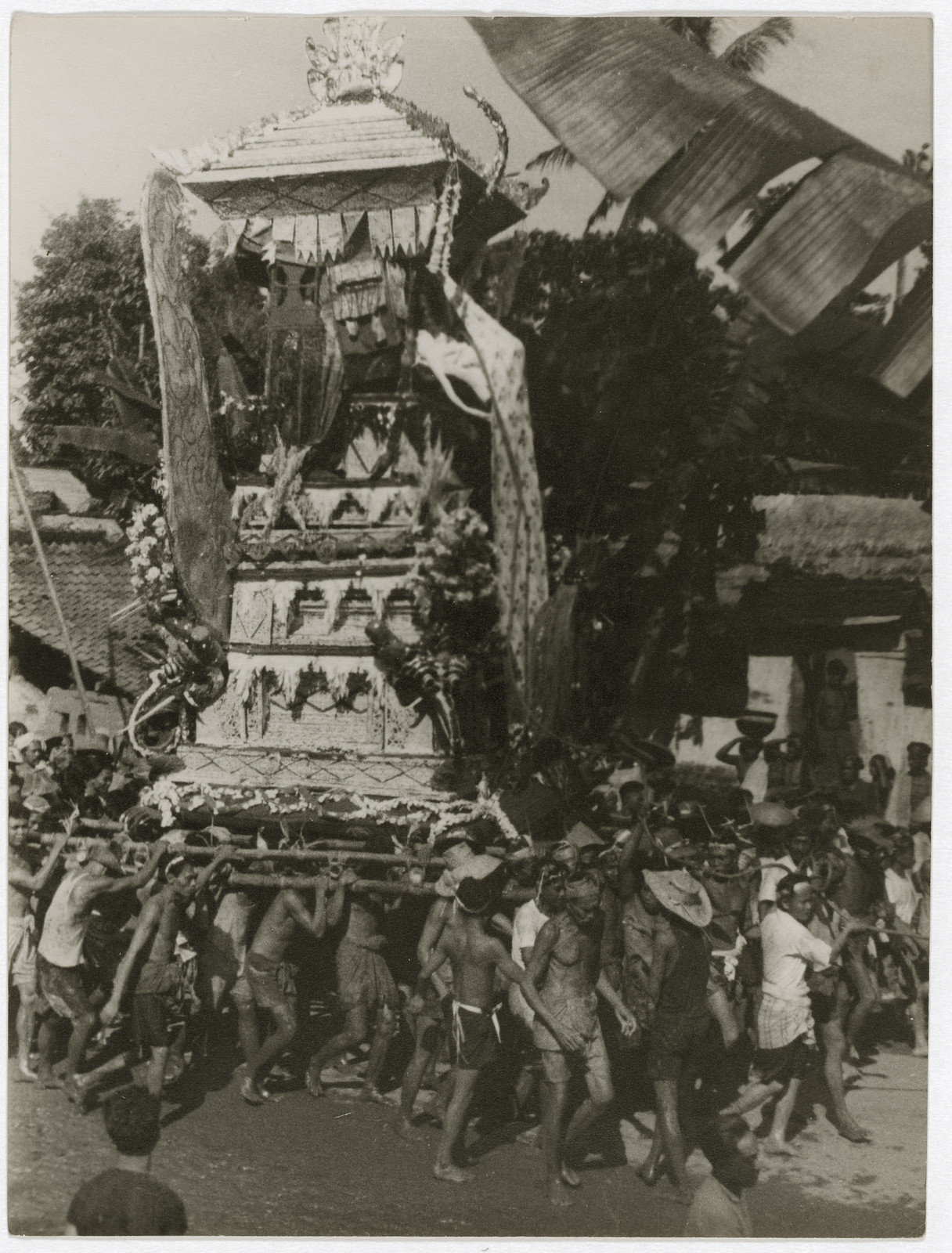 Balinese cremation tower carried in a funeral procession — historic image