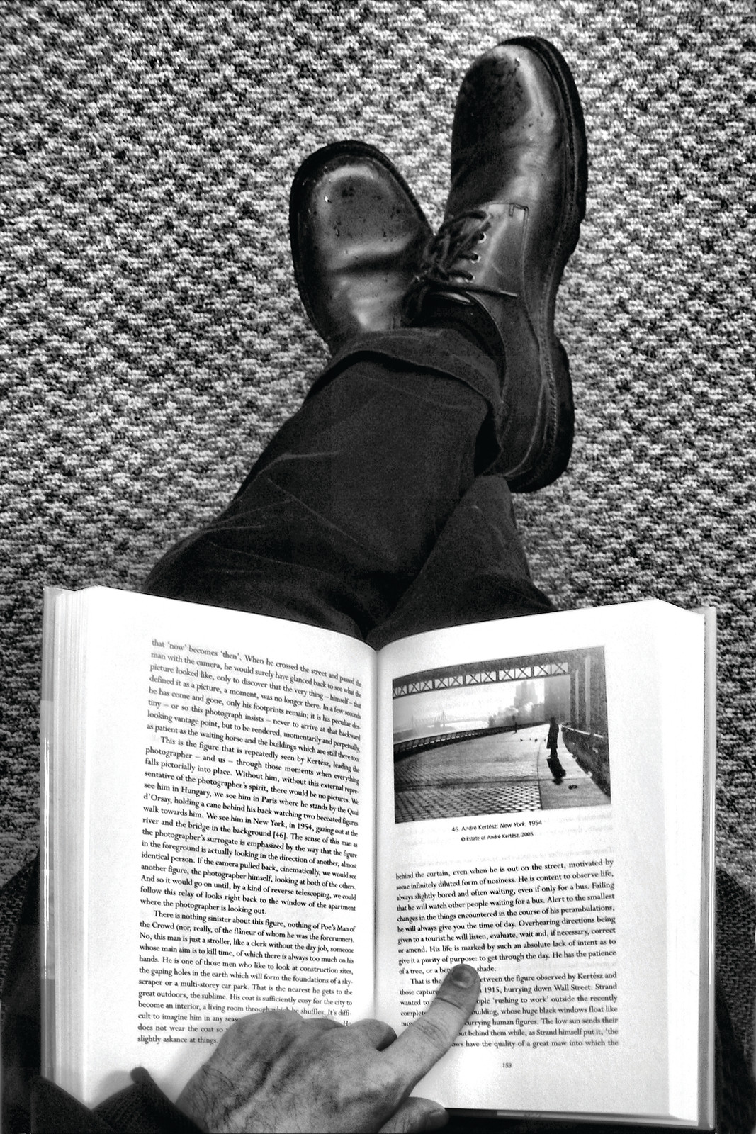 Feet on carpet while reading a book about photography — historic photograph