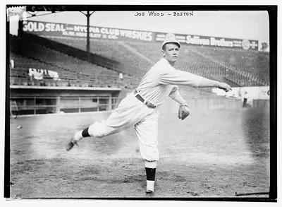 Joe Wood pitching, Boston, Sold Seal whiskey sign