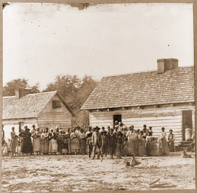Large group of slaves(?) standing in front of buildings on Smiths Plantation Beaufo