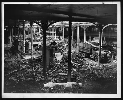 Demolition of iron-columned market hall with dump truck