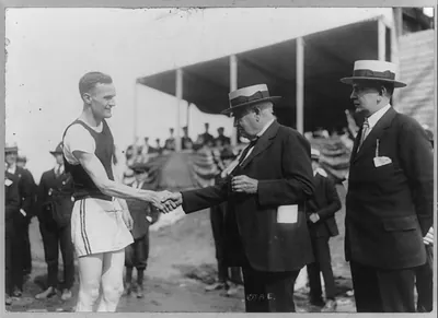 Mr. Thomas A. Edison shaking hands with winner of Grand Prix [runner]