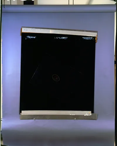 Black glass plate labelled #16 on blue backing